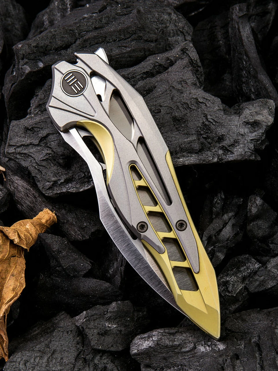 We Knife Co. We Knife Arrakis Framelock Folder 906C, 3.45” Bohler M390 Satin Wharncliffe Plain Blade, Gold and Gray Titanium Handle 3 We Knife Co. We Knife Arrakis Framelock Folder 906C, 3.45” Bohler M390 Satin Wharncliffe Plain Blade, Gold and Gray Titanium Handle - Image 3